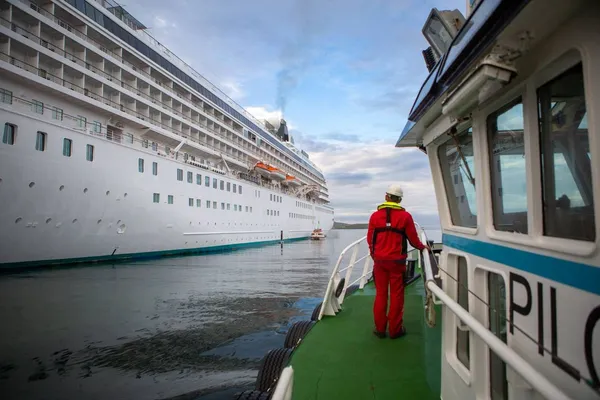 Pilot boat approaching a cruise ship