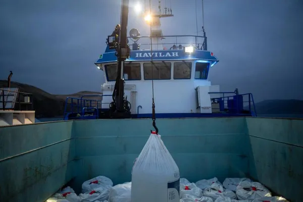 Salmon feed being lifted onto a feed barge