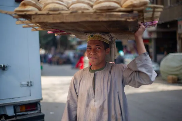 Boy carrying bread